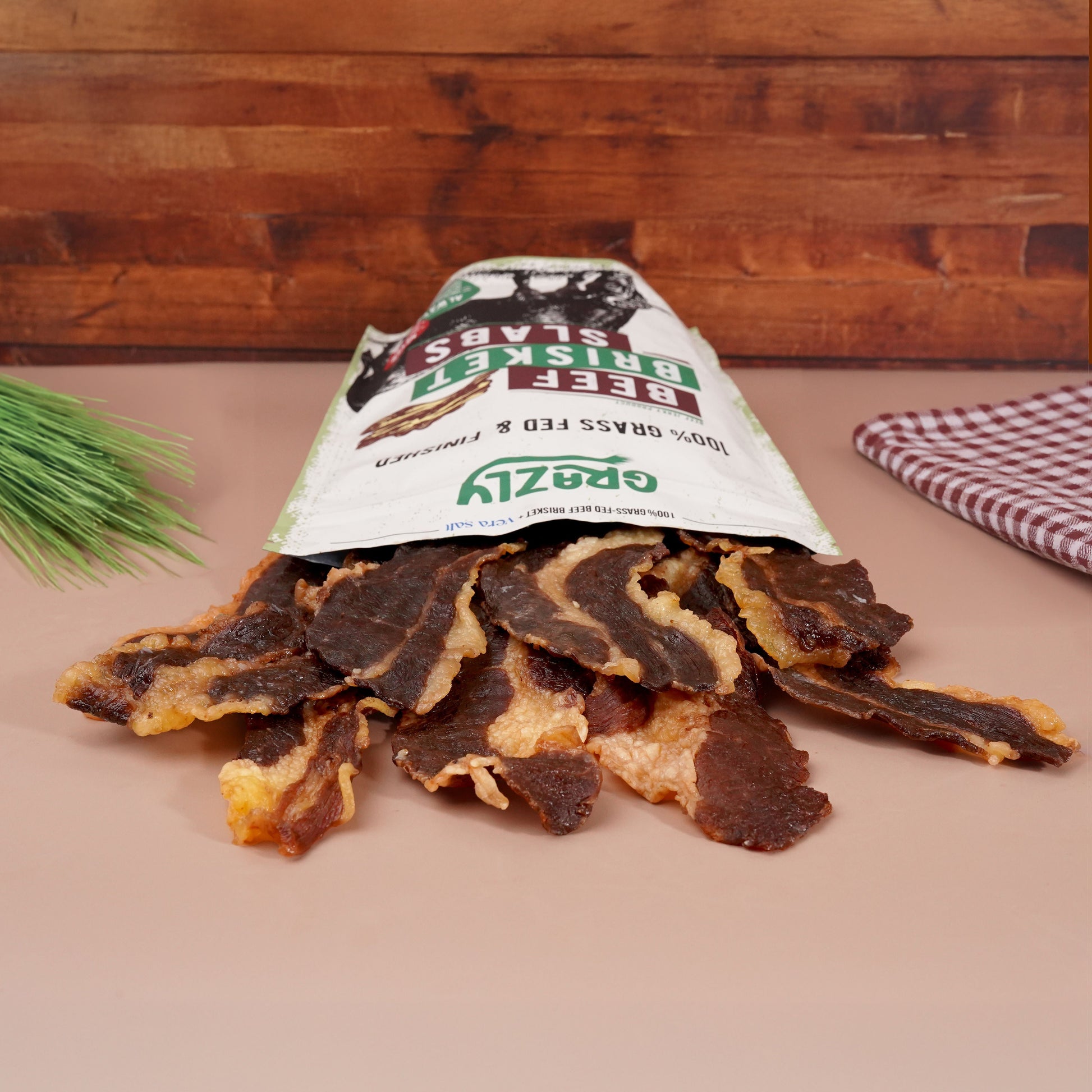 Bag of Grazly Beef Brisket Slabs spilled out onto beige table