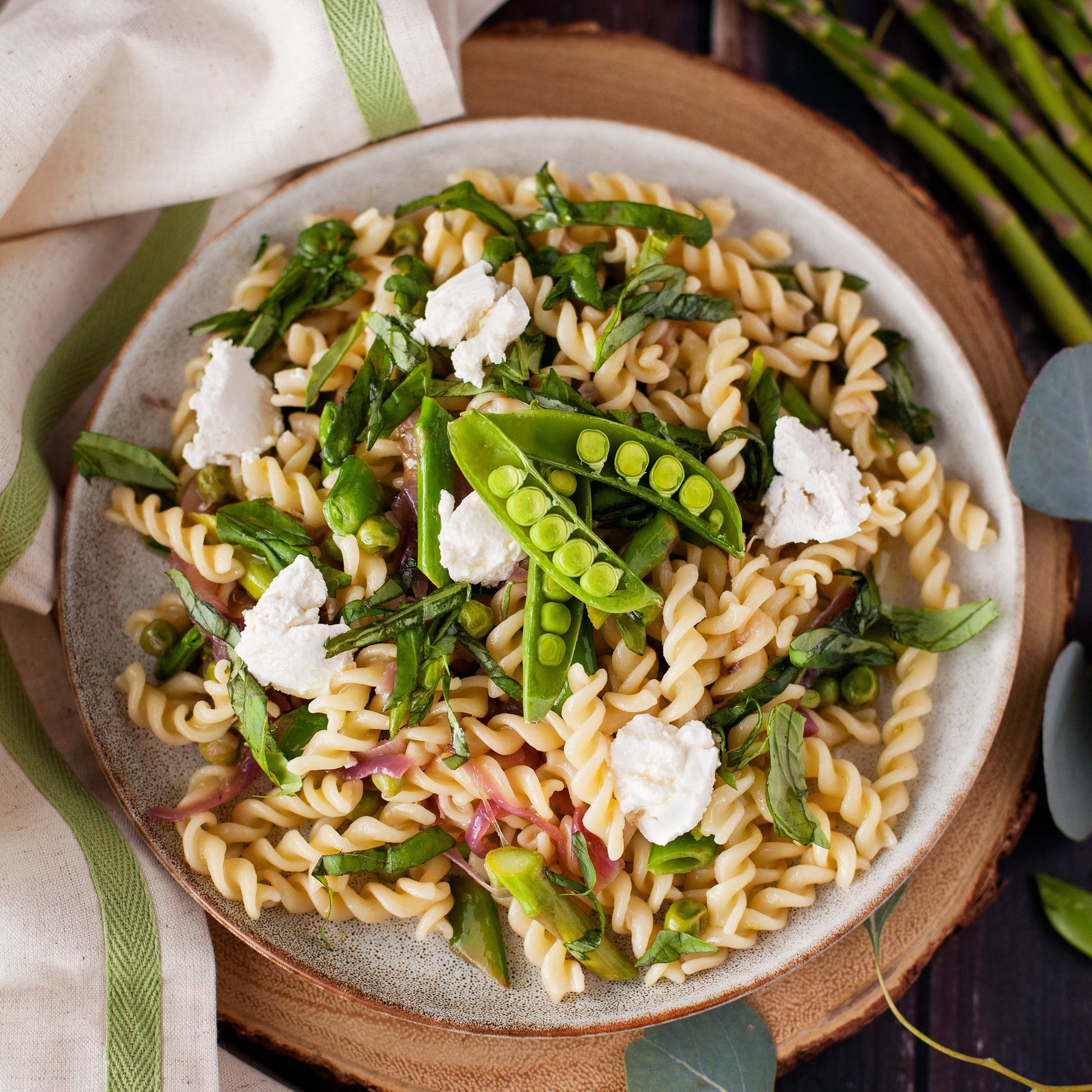 Sourdough pasta dish with green peas and herbs on a plate